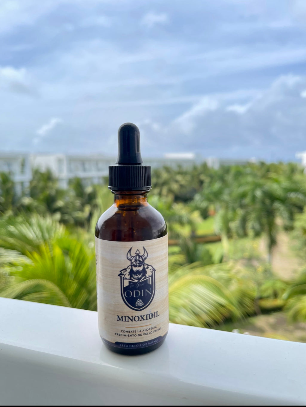 Minoxidil treatment for hair growth by The Great Odin, applied on palms with a focus on healthy, thick hair.